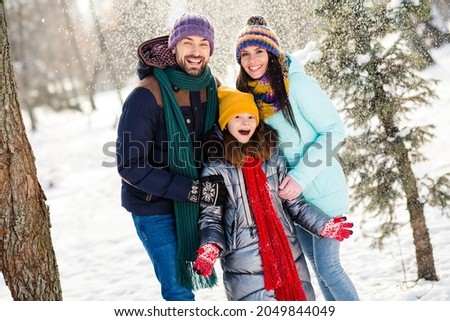 Photo of cheerful lovely family mommy daddy daughter happy positive smile snowy weather walk park weekend Royalty-Free Stock Photo #2049844049
