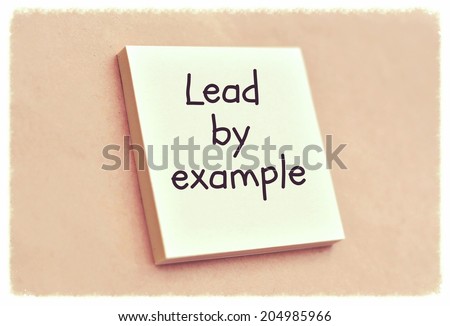 Text lead by example on the short note texture background