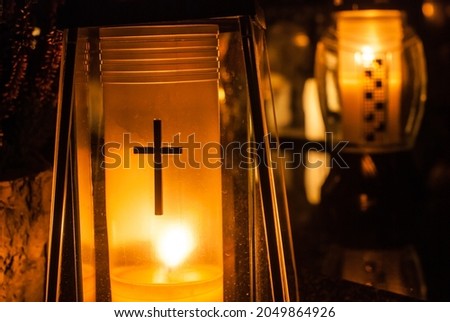 Yellow grave candles shining with light. Cemetery at night. Catholic Halloween tradition. All souls' day in Poland, Eastern Europe. Zaduszki. Royalty-Free Stock Photo #2049864926