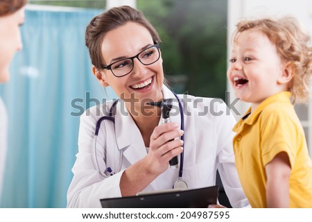 Happy little boy after health exam at doctor's office Royalty-Free Stock Photo #204987595