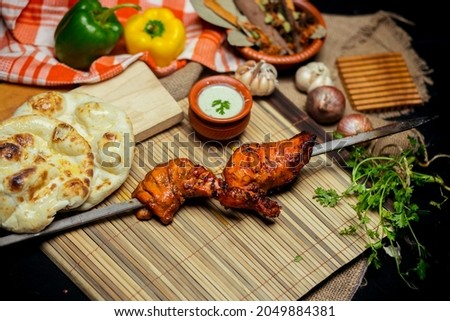 Traditional kacchi, chicken curry, kebab, naan made for commercial food photography 