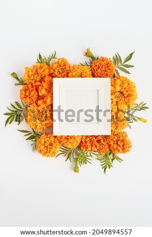 autumnal composition of flowers and photo frames with place for text. simple flat lay, copy space.