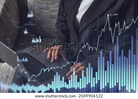 Woman typing the keyboard to research stock market to proceed right investment solutions. Internet trading and wealth management concept. Formal wear. Hologram Forex chart over close up shot.