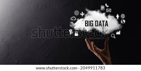 Businessman holds the inscription , word BIG DATA. Padlock , brain ,man, planet,graph, magnifier, gears, cloud, grid, document, letter, phone icon