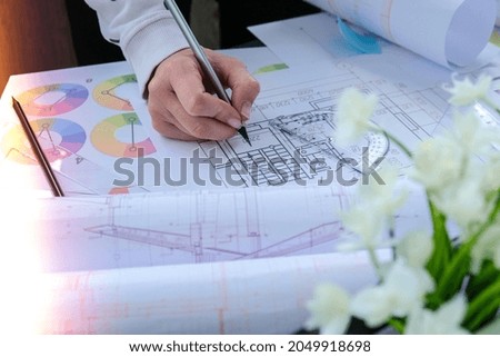 Hands use pencil with a protractor. Architectural Project drawings with tools. Architects workplace. Engineering Interior designer's working table. Workspace