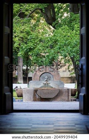 Fountain-a drinking bowl. View of the fountain-drinking bowl from the Kazan Cathedral. 
Translation: Made in 1809.
