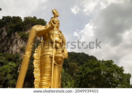 The huge statue Sri Muruga, the Hindu god of war, guards the access area to the Batu Caves, in the Gombak District, Selangor, Malaysia