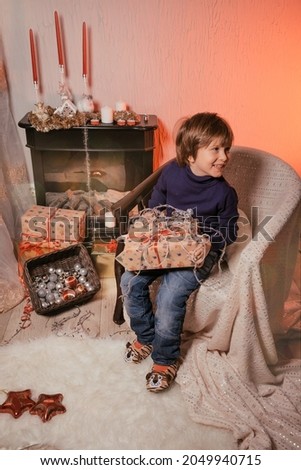 Christmas Child Happy Boy , Magic Light in Box, Kid sitting front of Xmas Tree