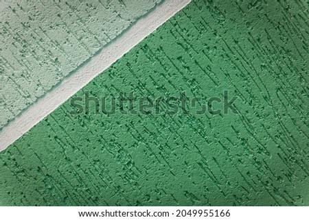 Green background with decorative plaster and diagonal lines