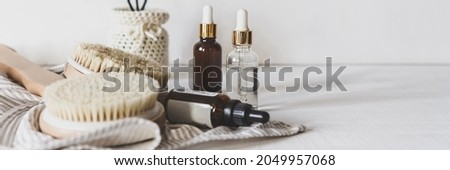 Zero waste, sustainable bathroom and lifestyle. Bamboo massage brush, loofah sponge, natural oil, DIY products in glass bottles on white background.Eco cosmetics