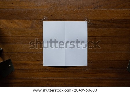 White square paper attached on wood background