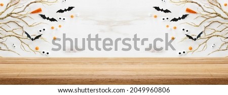 Halloween holiday concept. Empty rustic table in front of bare trees and bats background. Ready for product display montage