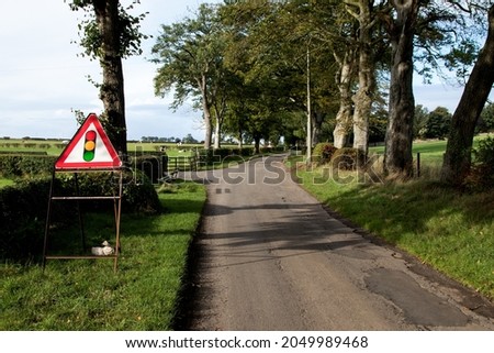 Temporary traffic lights warning sign on a country lane