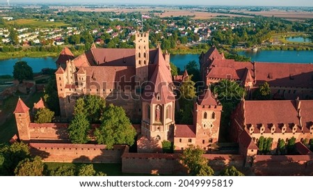 Malbork,Poland. Aerial photo from drone to Medieval Malbork ( Zamek w Maborku, Ordensburg Marienburg ),castle in Poland fortress of the Teutonic Knights at the Nogat river in sunrise light.(Series)