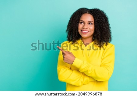 Photo portrait woman smiling pointing copyspace isolated vivid teal color background