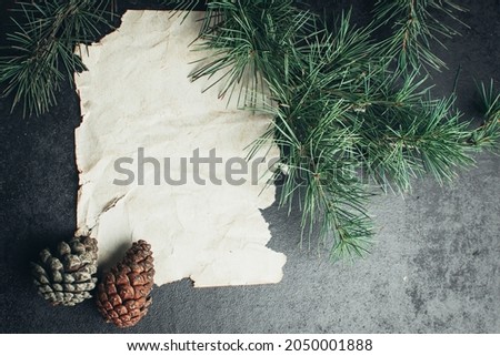 old crumpled paper and Christmas tree branches on wooden surface