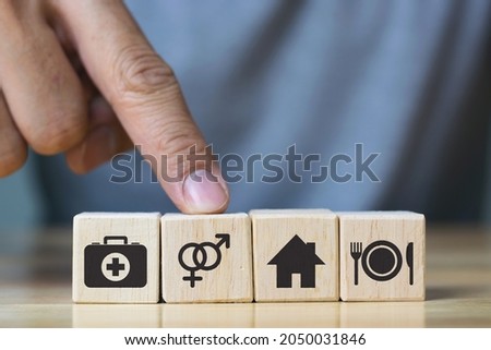 human hand placing cube with food Clothing, housing, medicine, four basic human needs concept.
