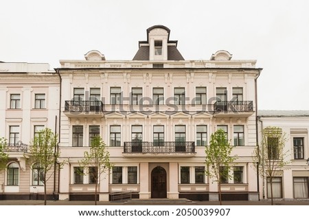 A very old, well-preserved building with balconies in the classical style, equipped with a ramp for few mobile citizens. Building with expressive balconies. Royalty-Free Stock Photo #2050039907