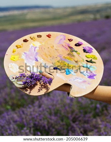 Young artist painting an floral landscape