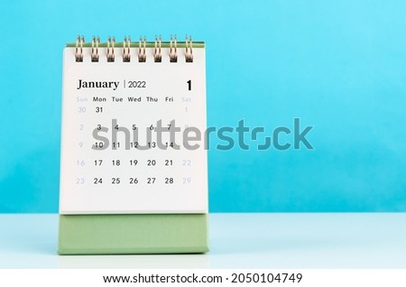 January 2022 desk calendar on blue background. Royalty-Free Stock Photo #2050104749