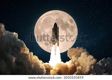New space rocket with smoke and clouds takes off into the sky with full moon. Shuttle spaceship liftoff. Space Mission Launch Concept.  Royalty-Free Stock Photo #2050105859