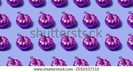 Seamless pattern with golden pink pumpkins on a violet background. Autumn concept in a modern style. High quality photo