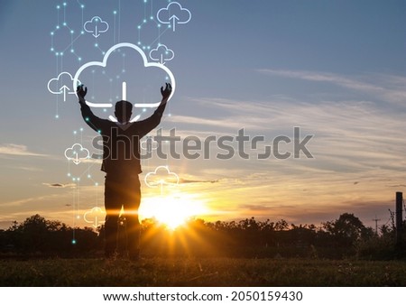 Silhouette young man standing with ccloud uploading data on the Internet online.network,media,keyword,Digital Web,Photo concept information and Technology.