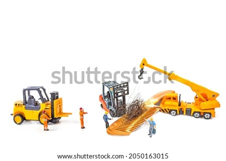 selective focus photo of miniature workers with hair on wooden comb, abstract background to solution hair loss concept.
