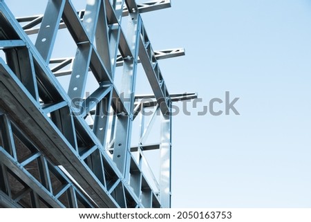 Engineer technician watching team of workers on high steel platform