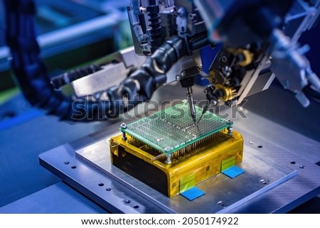 Soldering transistor microcircuit. Creation microprocessor. Microprocessor soldering machine. Microcircuit inside some equipment. Chip cooling system. Concept production of microcircuits for cars Royalty-Free Stock Photo #2050174922