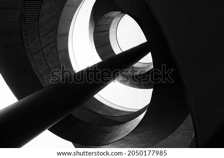 An abstraction composed of spiral metal structures, columns and concrete. Black and white photo Royalty-Free Stock Photo #2050177985