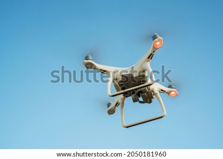 Unmanned Quadcopter with high definition Digital Camera, Flying Drone device for Aerial Video and Photo shooting modern Technologies concept picture wallpaper advertising background with copy space