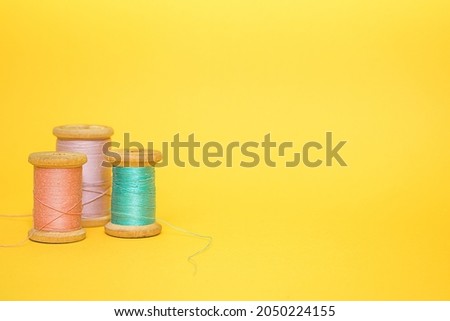 Three multi-colored spools of thread Royalty-Free Stock Photo #2050224155