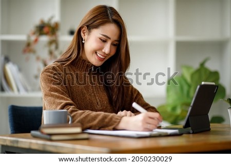 Professional young asian business woman using computer laptop and Talking On Phone Working On Laptop In Modern Office.	