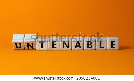 Tenable or untenable symbol. Turned wooden cubes and changed the word 'untenable' to 'tenable'. Beautiful orange table, orange background. Business, tenable or untenable concept, copy space.