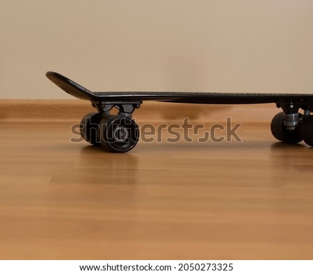 children's skateboard close-up on a parquet wooden floor. sports and recreation at home