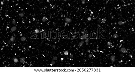falling down real snow, snowstorm weather stock image on black background