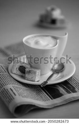 Coffee cup and newspaper. black and white foto. High quality photo