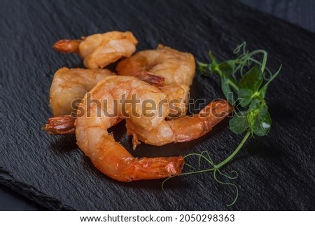 Fried prawns on a black stone tray. Seafood