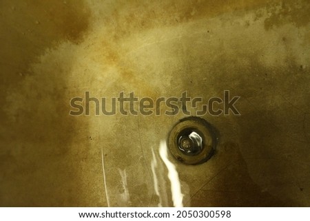 Drain hole in dirty bathtub, blurred photo