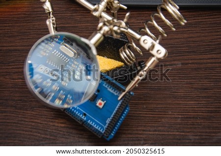 repairs the phone and examines small details with a magnifying glass wite background