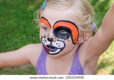 beautiful blond girl with face painting of dog