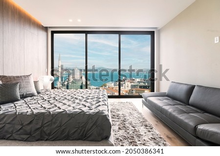 Modern and luxurious master bedroom with views of Istanbul and the Bosporus. Condo or Hotel accommodation. Royalty-Free Stock Photo #2050386341