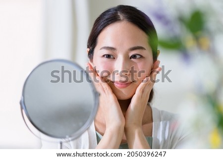 Woman watching mirror skin care (beauty image)