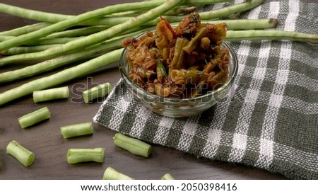 French beans with stewed green peas on wooden background. Healthy food concept.