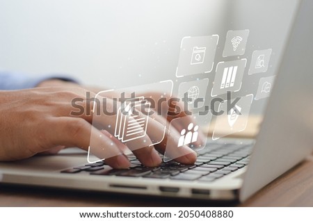 a business man using a computer to manage documents online document communication database and digital file storage systems software record keeping database technology file Royalty-Free Stock Photo #2050408880
