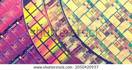 silicon chip wafer reflecting different colors Royalty-Free Stock Photo #2050420937