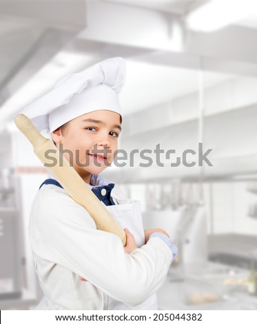 Young chef in the kitchen Royalty-Free Stock Photo #205044382
