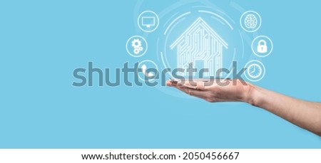 Hand hold house icon.Smart home controlled, intelligent house, and home automation app concept.Pcb design and person with smart phone. Innovation technology internet Network Concept