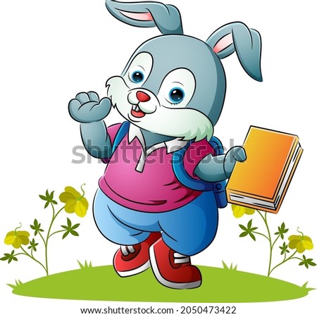 The cute rabbit is holding the colorful book of illustration